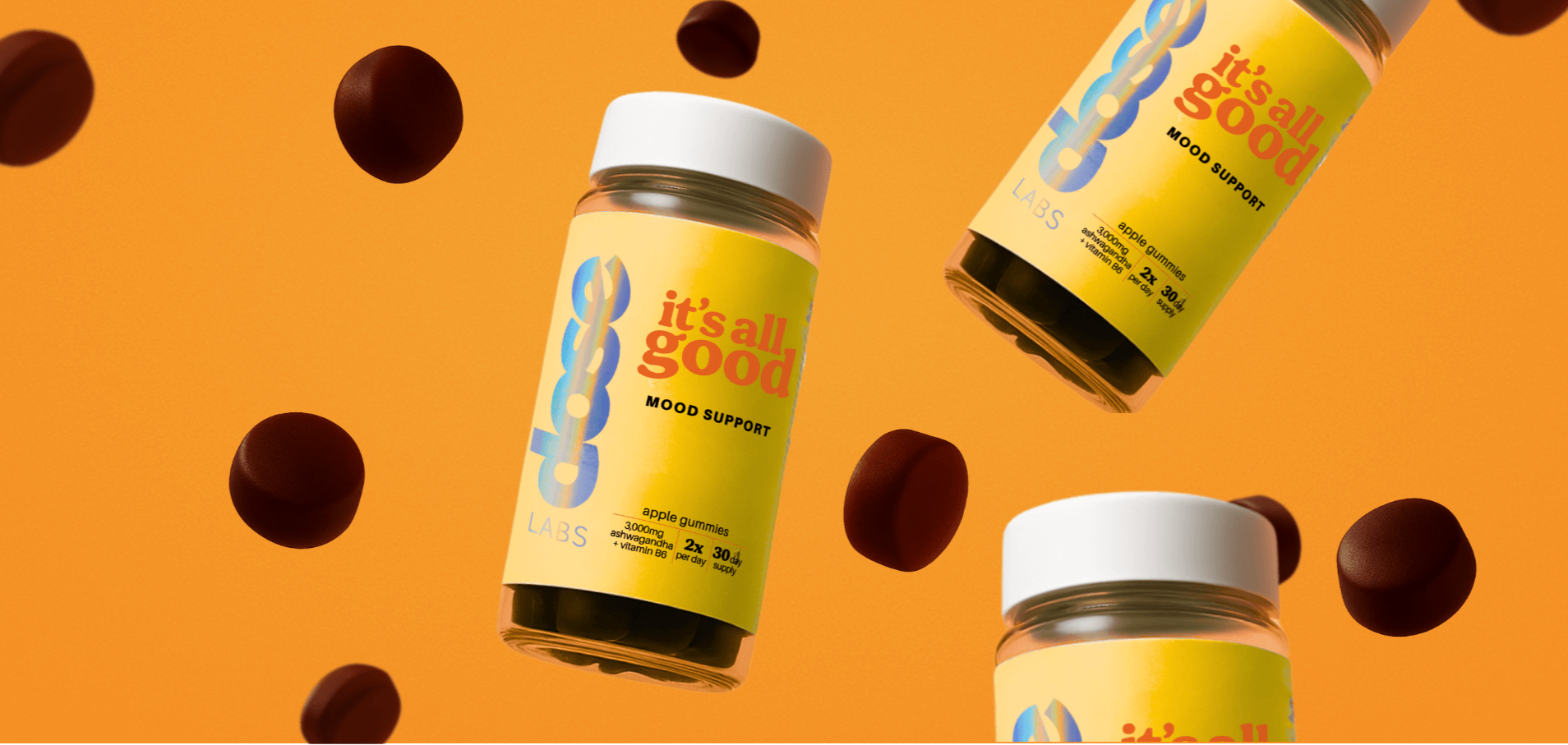 Jars of 'it's all good' mood support supplement on an orange background with scattered gummies