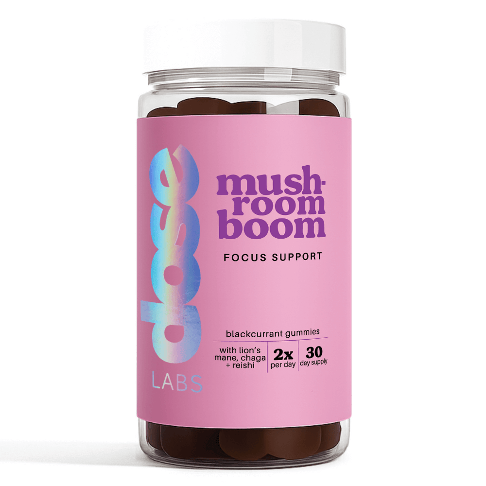 Bottle of 'mushroom boom' focus support gummies with a pink label on a white background