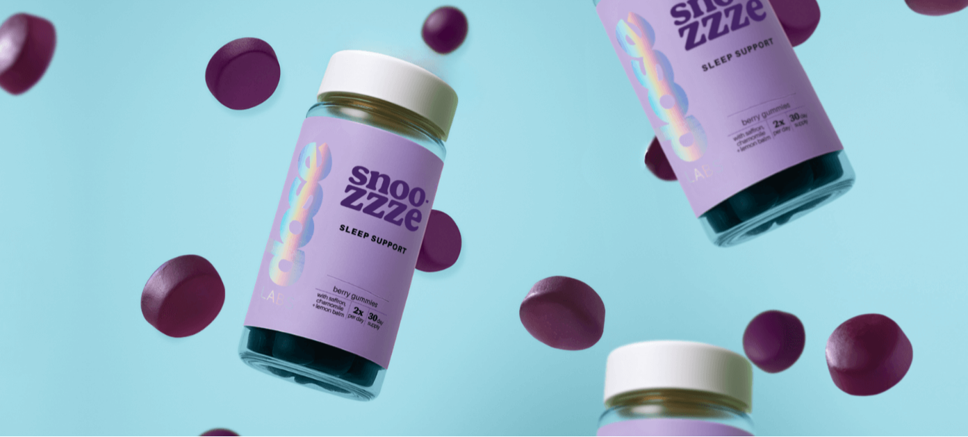 Snooze Zzzze sleep support supplement bottles with purple capsules on a light blue background