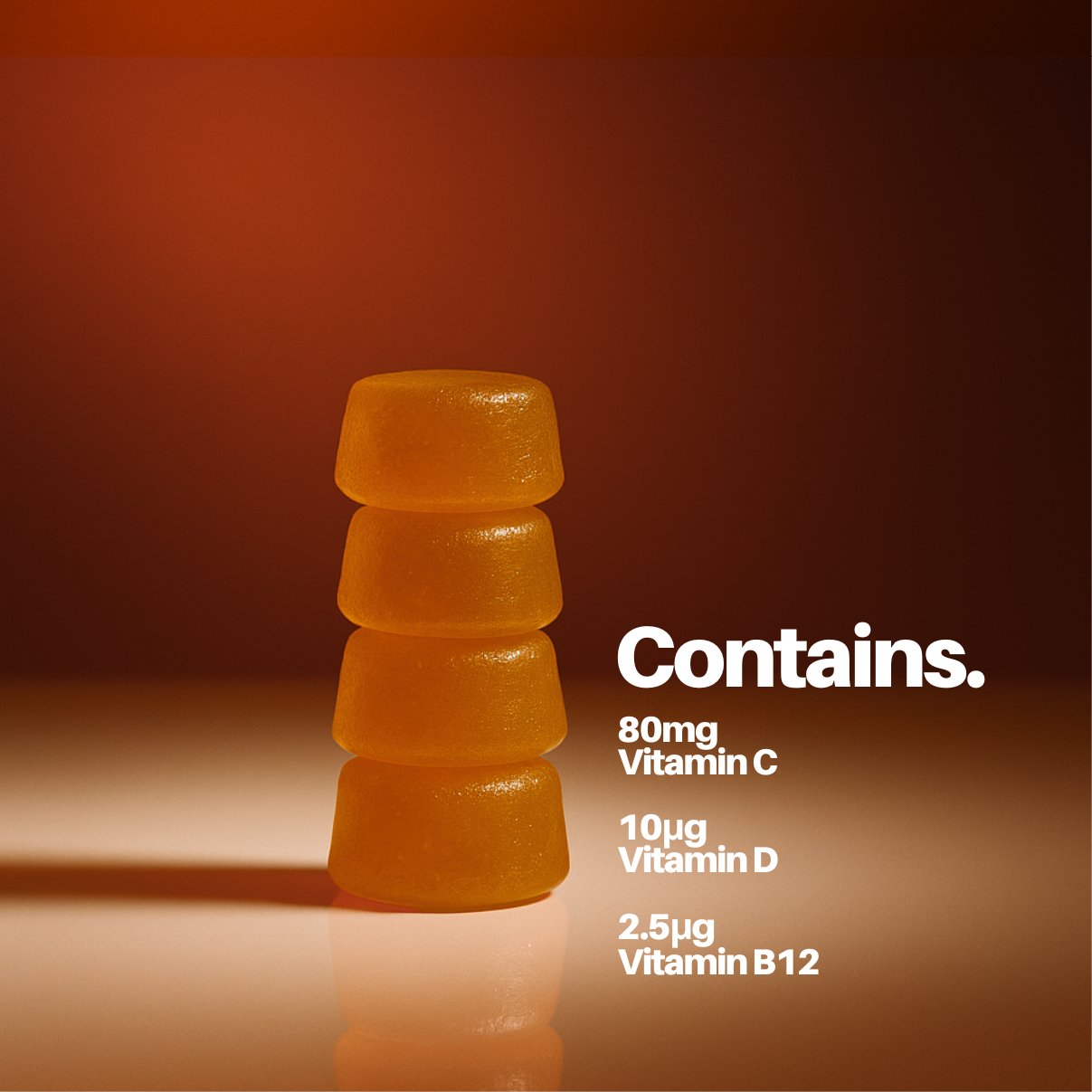 Stack of orange gummy vitamins with vitamin information on a brown background